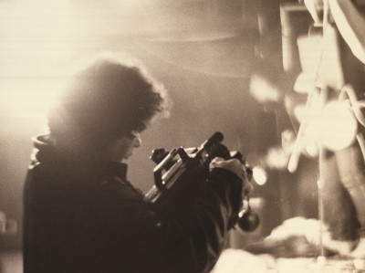 sepia photo of Artie Freedman in silhouette with a video camera at show